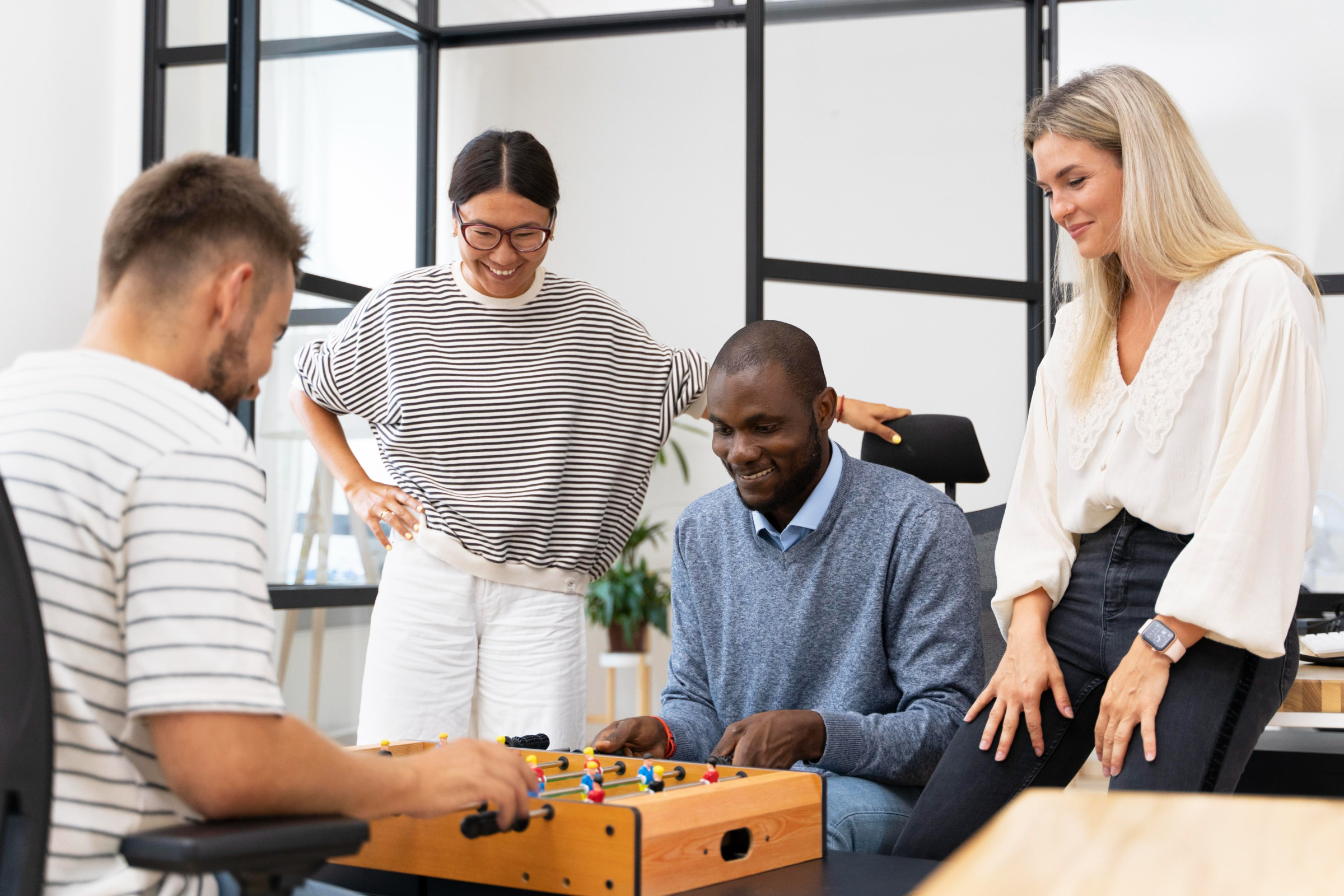 Close up on people having fun while playing table soccer - Image by Freepik